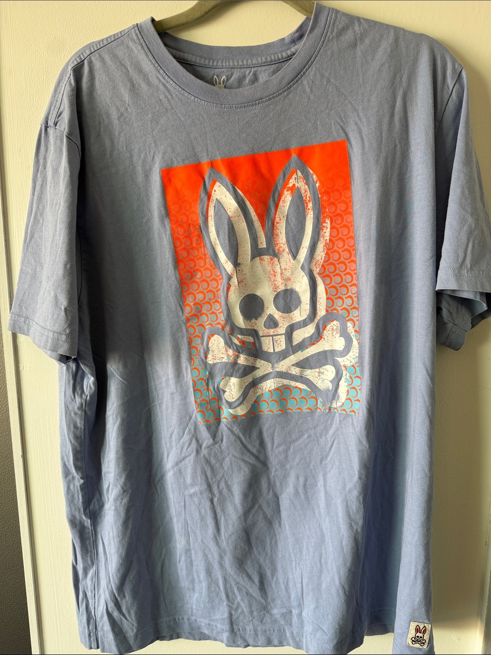 Psycho Bunny Short Sleeve Tee in Light Blue with Orange Graphic